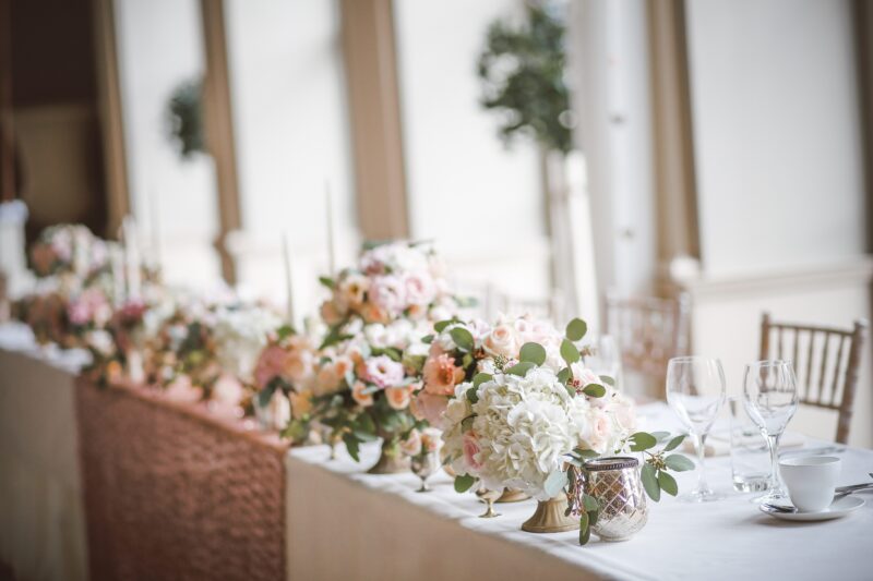 Long table covered in light pink and white bouquets at our Memphis hotel
